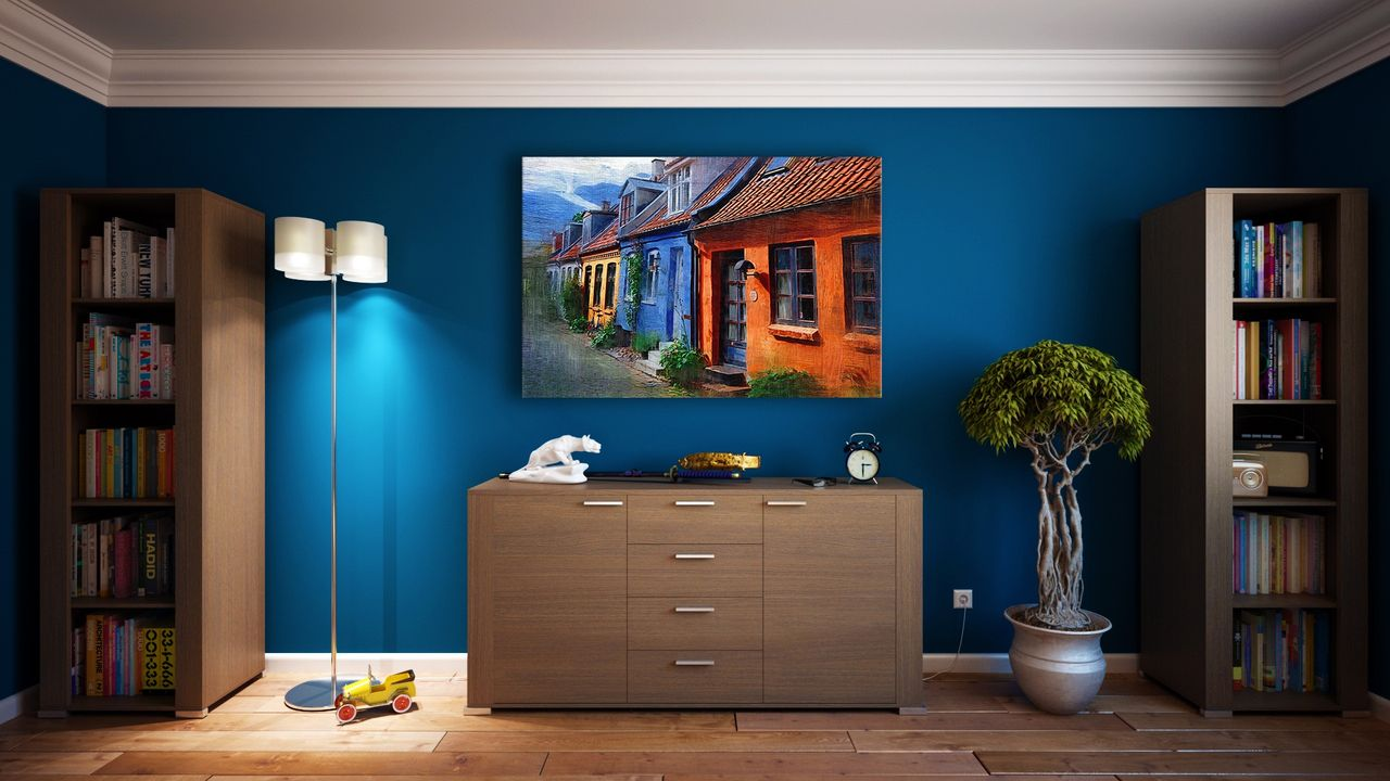 Mastering the First Impression: Your intriguing post title goes here A modern living room featuring stylish bookshelves, a vibrant painting, and minimalistic decor.