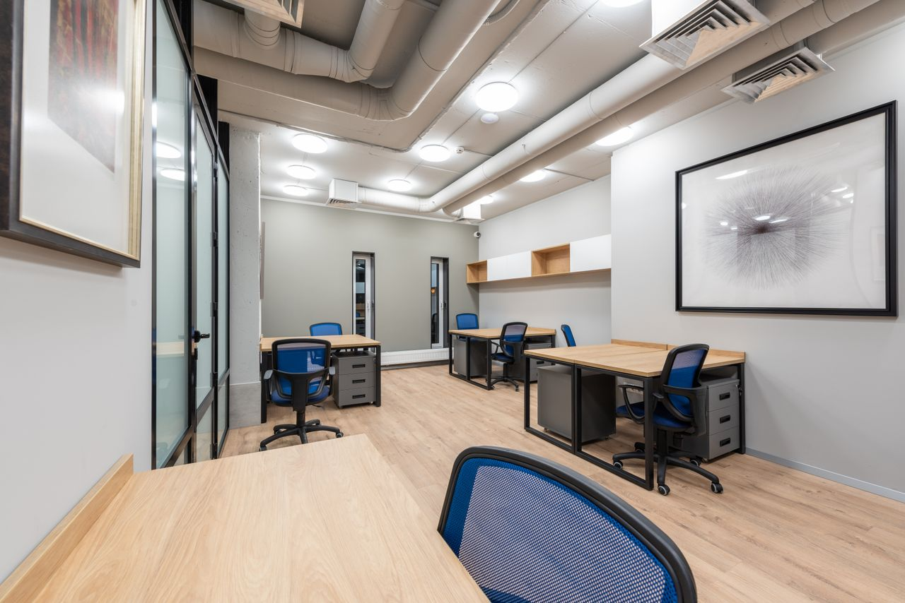 about-02 Contemporary office interior with desks, chairs, and abstract art. Ideal for business settings.